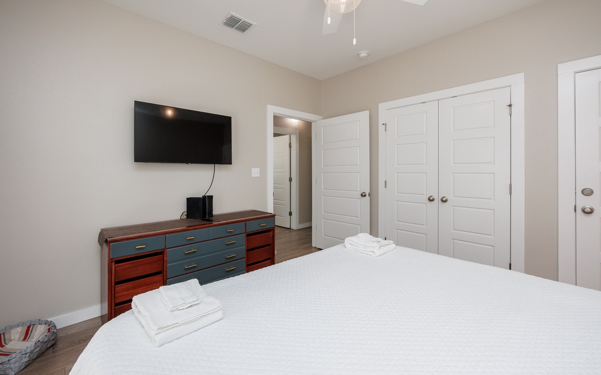 Rest peacefully in your comfortable bedroom with modern amenities, wall-mounted TV, and ample storage space for your belongings.