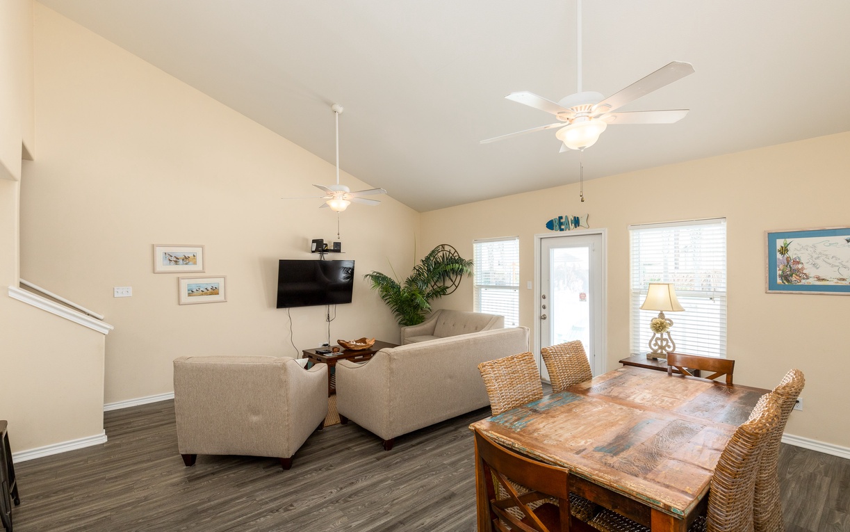 Relax in your bright, open living space with coastal charm, where ceiling fans keep you cool and comfortable seating invites leisurely evenings.