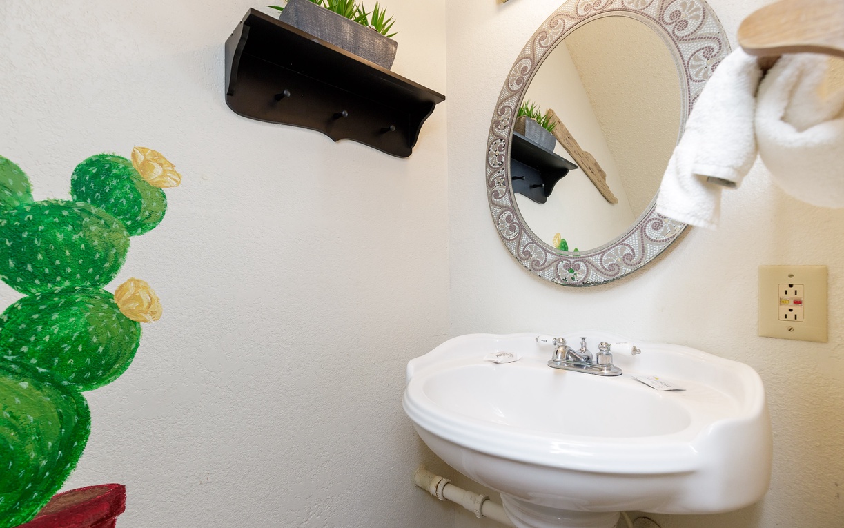 Freshen up in your charming half bath, complete with stylish touches and thoughtful amenities for your comfort.