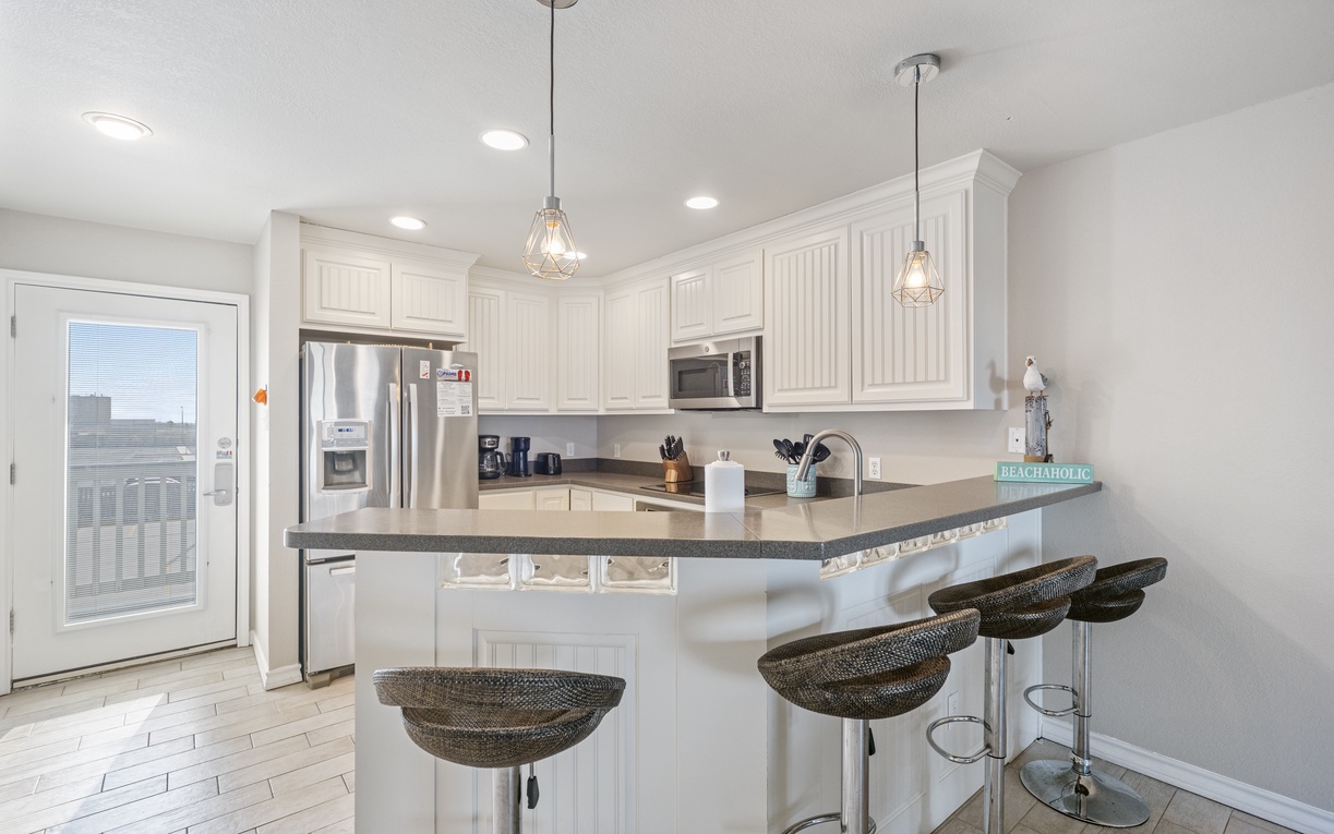 Cook memorable meals in your bright, fully-equipped kitchen with granite countertops, stainless appliances, and breakfast bar seating for casual dining.