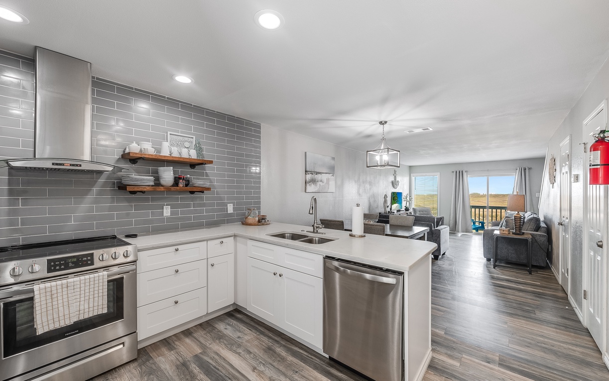 Cook your favorite meals in this bright, modern kitchen with stainless appliances and gleaming countertops that flow into your spacious living area.