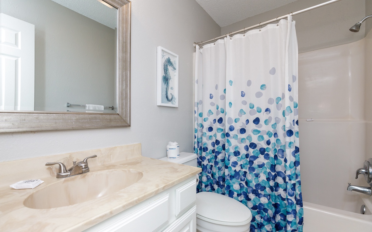 Refresh in your private bathroom with ocean-inspired touches and all essential amenities for a comfortable stay.