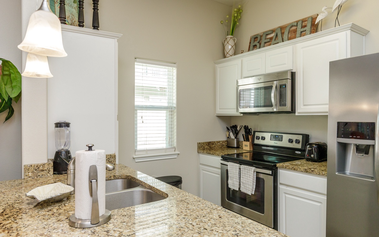 Cook up your favorite meals in this fully equipped kitchen featuring granite countertops, stainless steel appliances, and everything you need for a perfect stay.