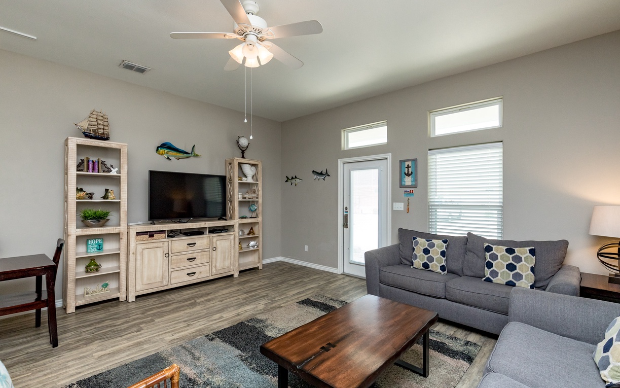 Sink into comfortable couches in your coastal-themed living room, where nautical touches create a relaxing beach house atmosphere.