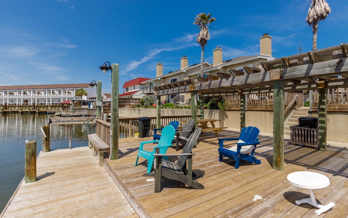 Picture yourself lounging in colorful Adirondack chairs on your private waterfront deck, watching boats drift by on calm waters.