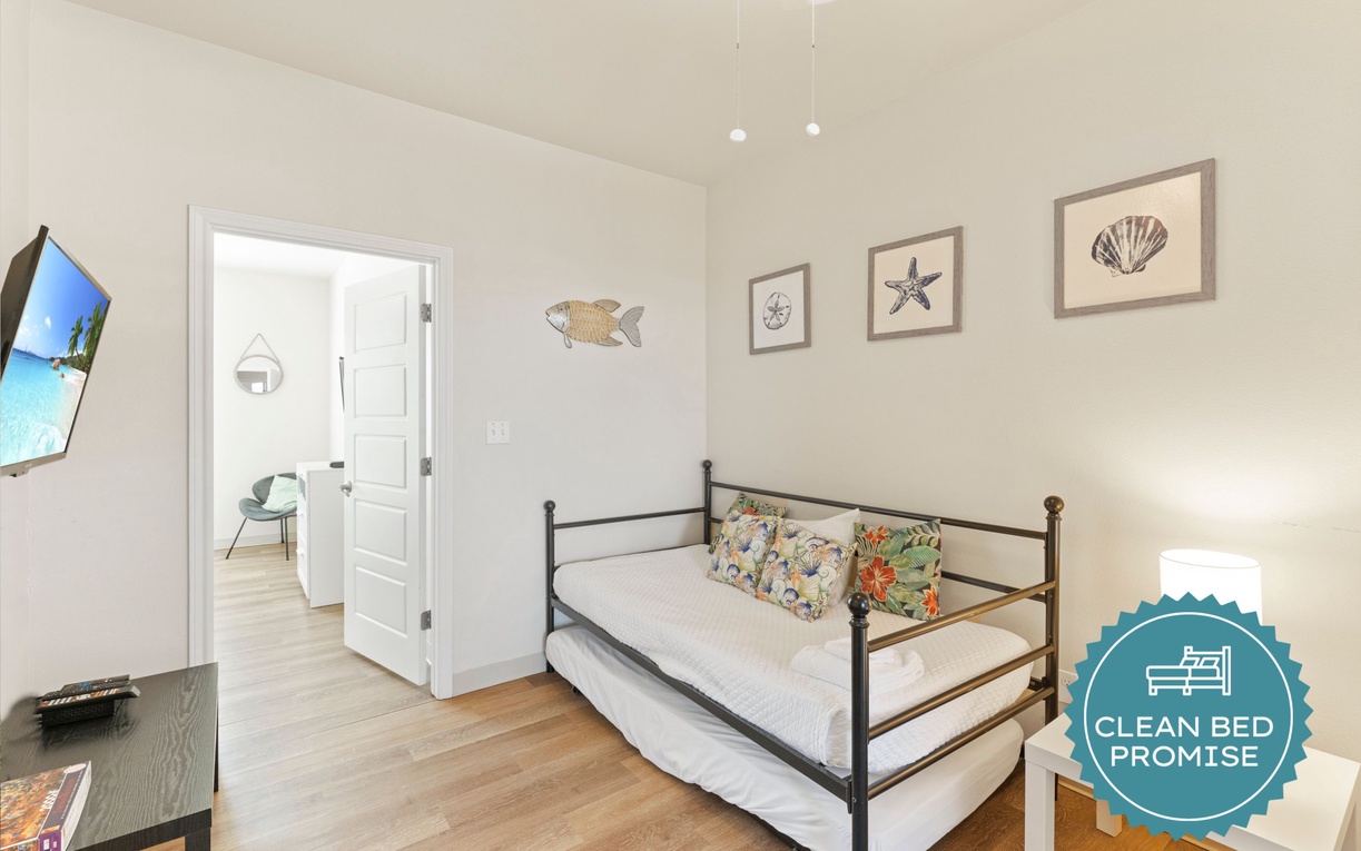 Unwind in your cozy coastal retreat with charming nautical touches, a comfy daybed, and bright natural light streaming through.