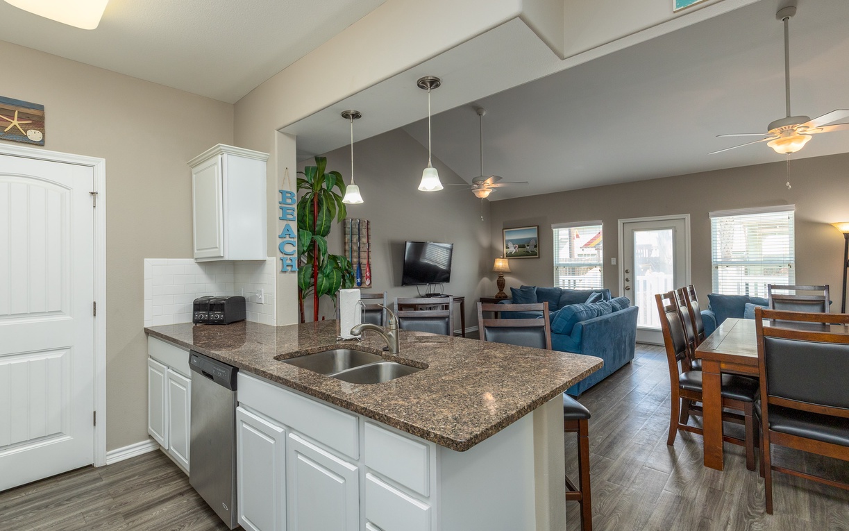 Your spacious kitchen island flows seamlessly into the cozy living area, perfect for cooking while chatting with loved ones.