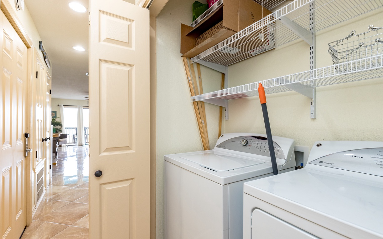 Your laundry area features full-size washer and dryer with convenient shelving for supplies and linens.