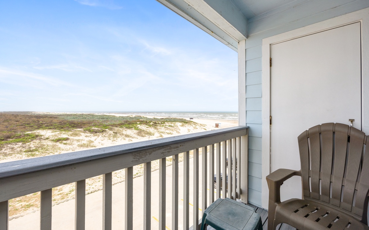 Settle into your private balcony chair and soak in sweeping coastal views. Your peaceful retreat overlooks sandy dunes and endless ocean horizons.