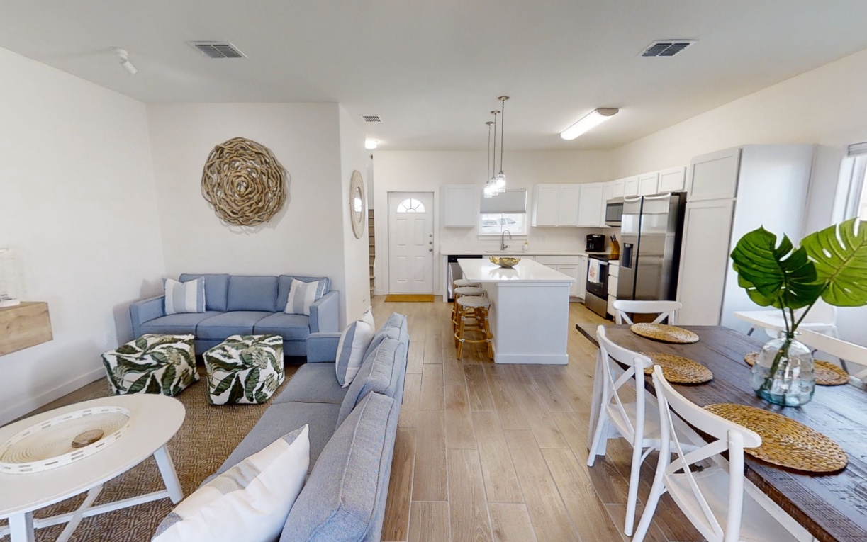 Relax in this bright open-concept space where coastal blues meet warm woods, creating your perfect home away from home.