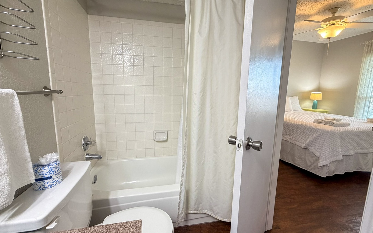 Step into your private bathroom featuring a deep soaking tub perfect for unwinding after exploring the area.