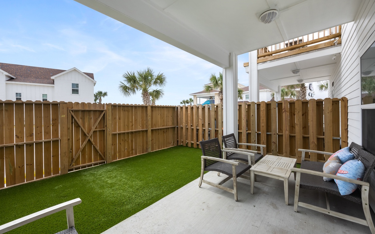 Relax in your private patio sanctuary with comfortable seating and artificial turf - perfect for morning coffee or evening unwinding.
