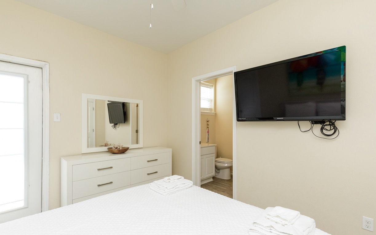 Relax in your serene bedroom featuring a queen size bed, ensuite bathroom, and private balcony with an amazing view of the gulf