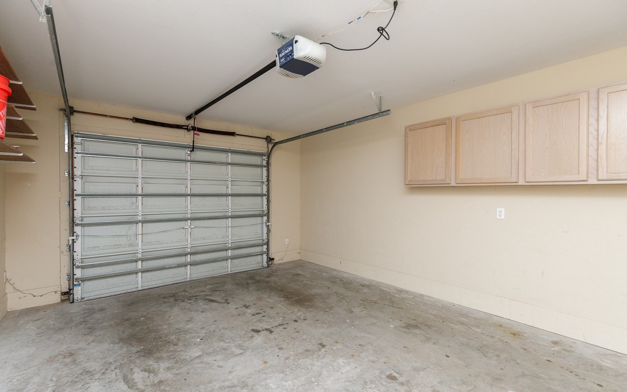 Secure garage with built-in storage cabinets provides convenient parking and extra space for your belongings during your stay.