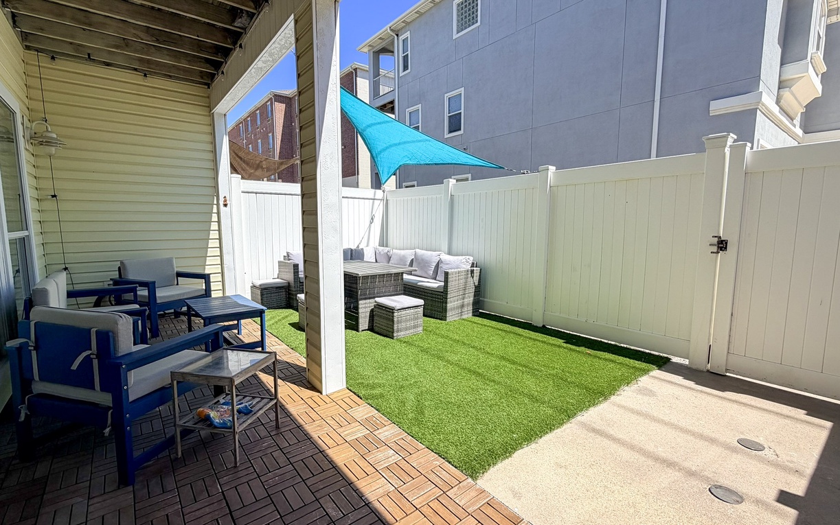 Your private outdoor oasis features cozy seating areas, vibrant shade sails, and comfortable dining space where you can unwind in style.