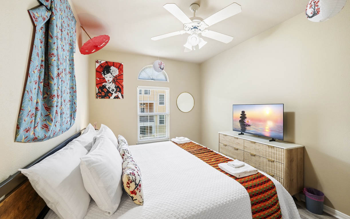 Unwind in your serene bedroom retreat with a plush bed, stylish decor, and a ceiling fan to keep you comfortable during your stay.