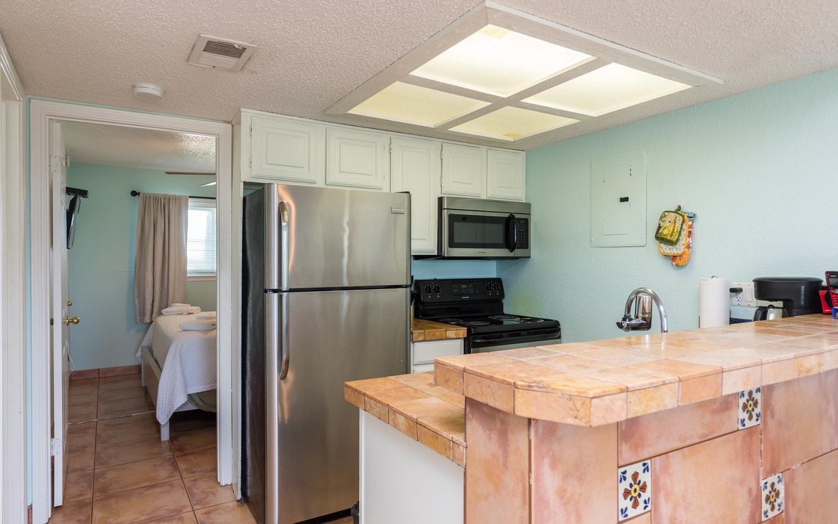 Your fully equipped kitchen features stainless steel appliances and charming tile details, perfect for preparing meals during your stay.