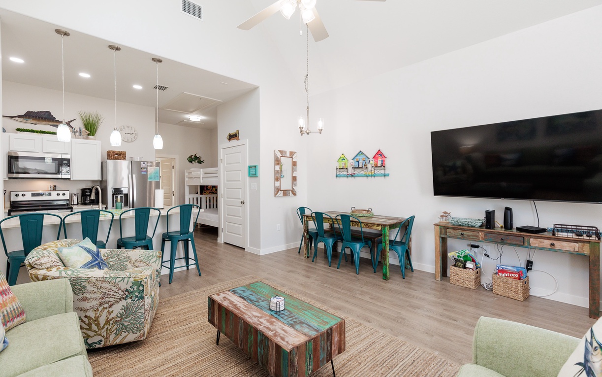Relax in your bright open-concept space with stylish coastal furnishings, modern kitchen, and entertainment center for memorable family gatherings.