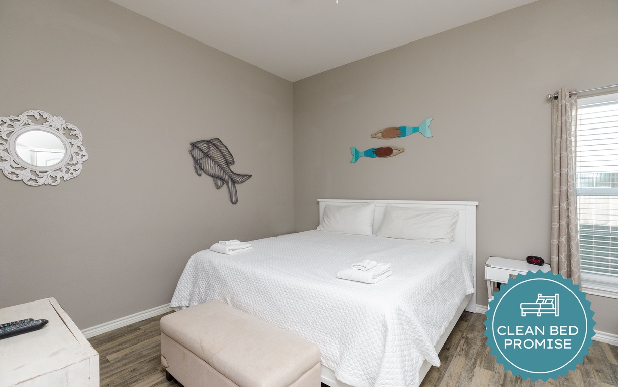 Drift into peaceful sleep in your cozy bedroom with crisp linens, playful coastal decor, and gentle natural light.