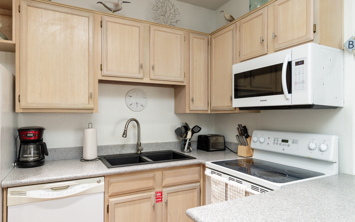 Your fully-equipped kitchen awaits with modern appliances and ample cabinet space for preparing home-cooked meals during your stay.