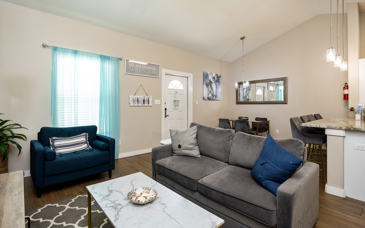 Unwind in your stylish living space with a full size sleeper sofa and a cozy blue accent chair, perfect for relaxing after your adventures.
