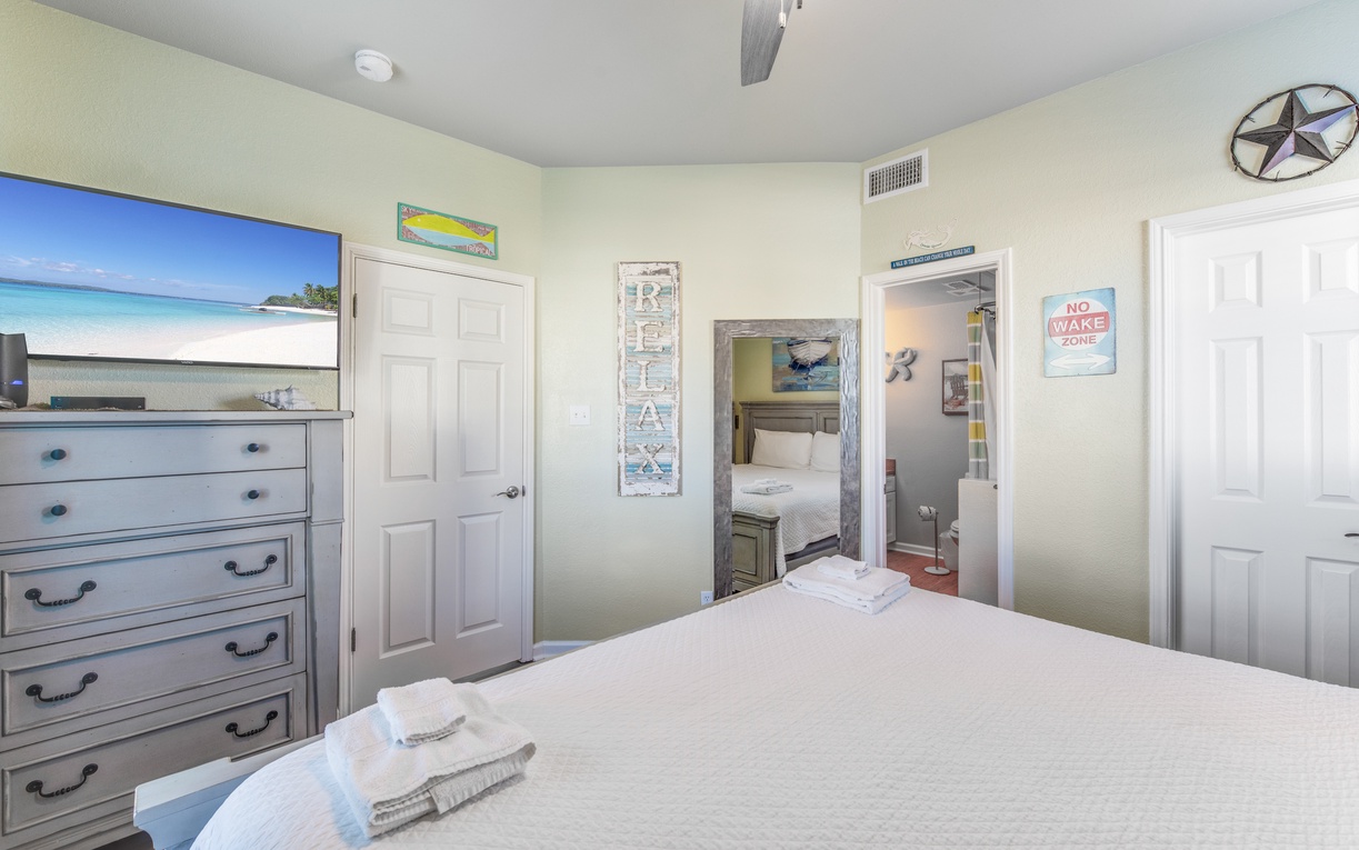 Relax in your coastal-themed bedroom with king size bed and beach artwork creating your perfect seaside retreat.