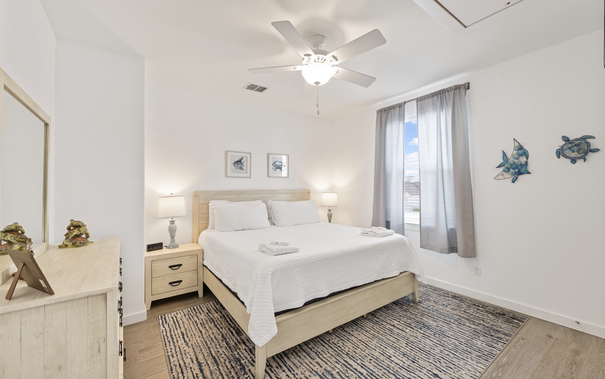 Drift into peaceful sleep in your serene bedroom with coastal charm, soft lighting, and gentle ceiling fan breeze.