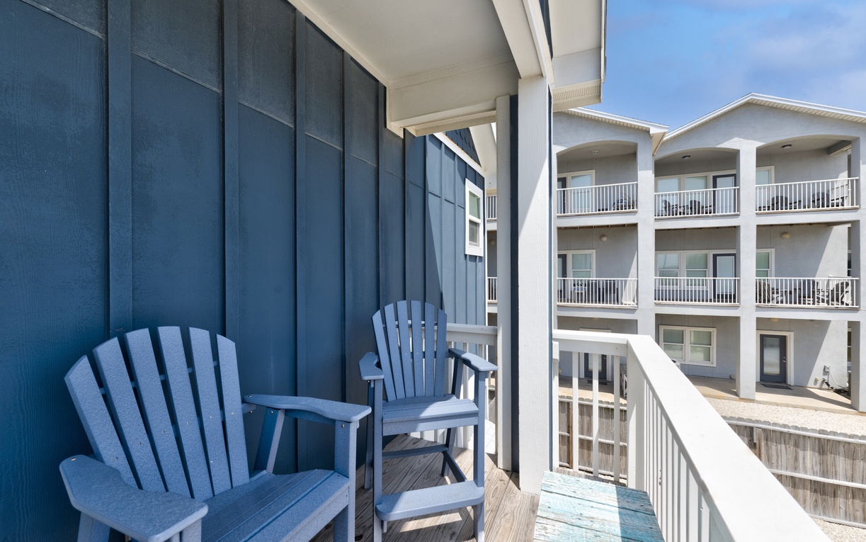 Relax in your private balcony chairs while enjoying peaceful views of the surrounding property and bright blue skies above.