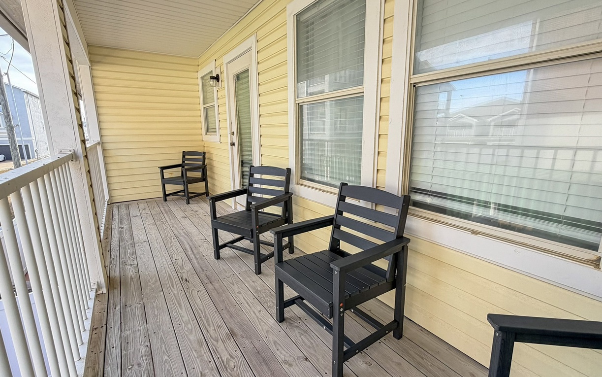 Step onto your private covered porch where comfortable seating awaits your morning coffee or evening relaxation.