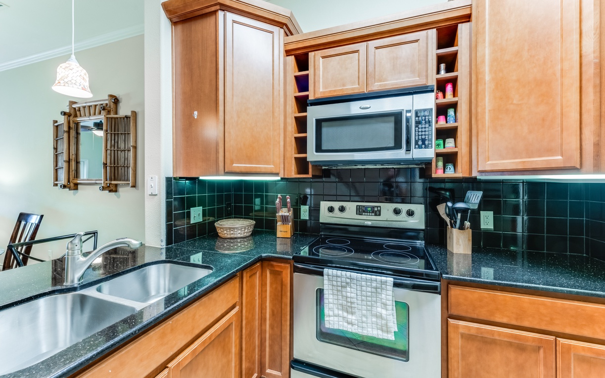 Cook your favorite meals in this fully-equipped kitchen with granite counters, modern appliances, and ample cabinet space for all your essentials.