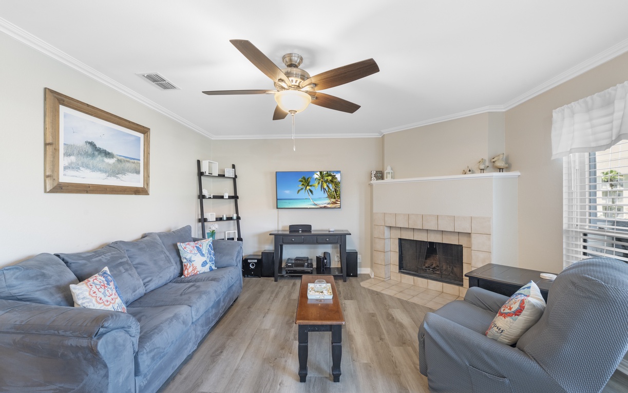 Relax in your spacious living room with plush seating, a cozy fireplace, and modern entertainment center for perfect evenings in.