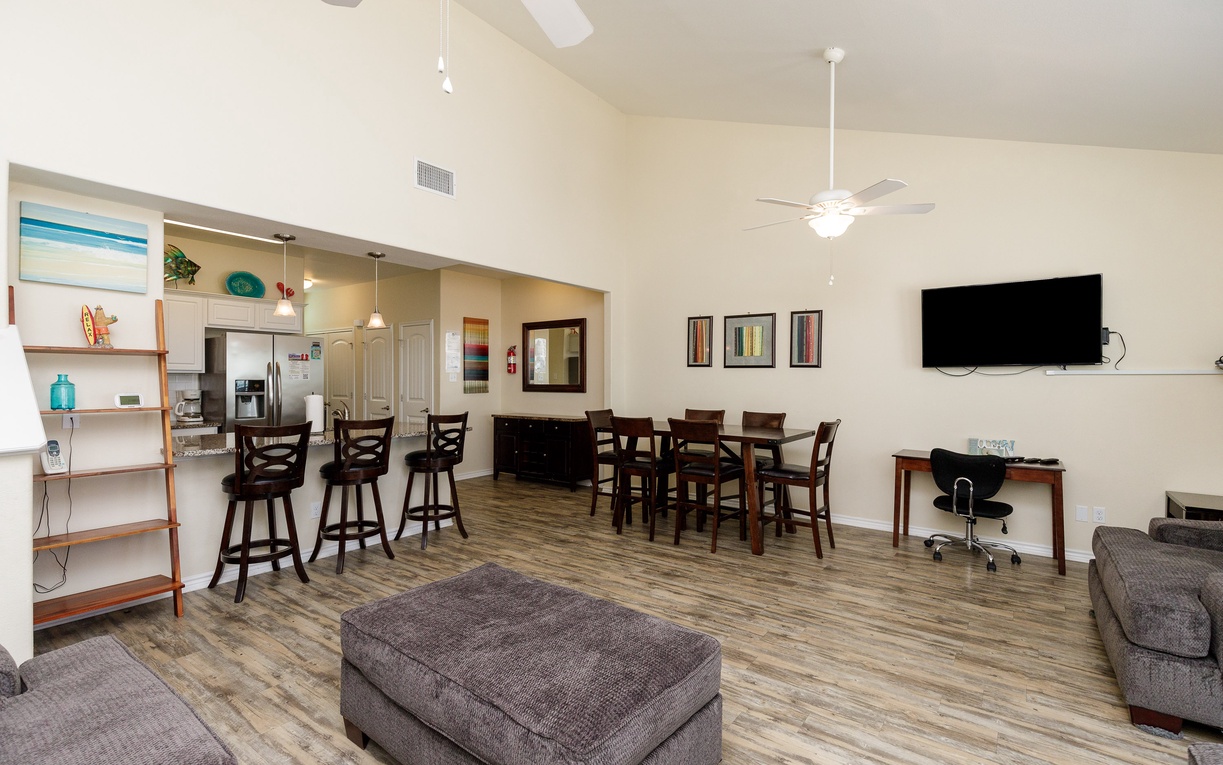 Relax in your spacious open-plan living area with modern kitchen, comfortable seating, and entertainment—perfect for gathering with loved ones.