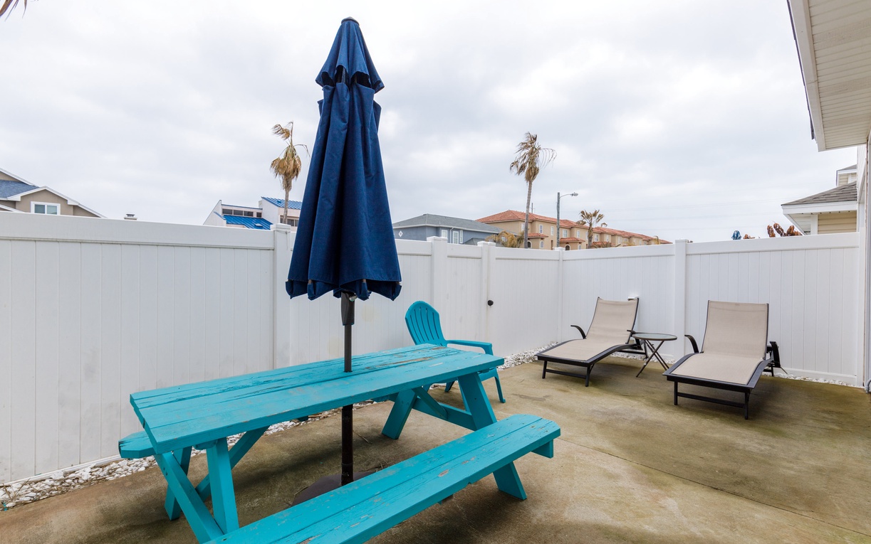 Your private patio awaits with a bright picnic table for outdoor meals and lounge chairs perfect for soaking up the California sun.