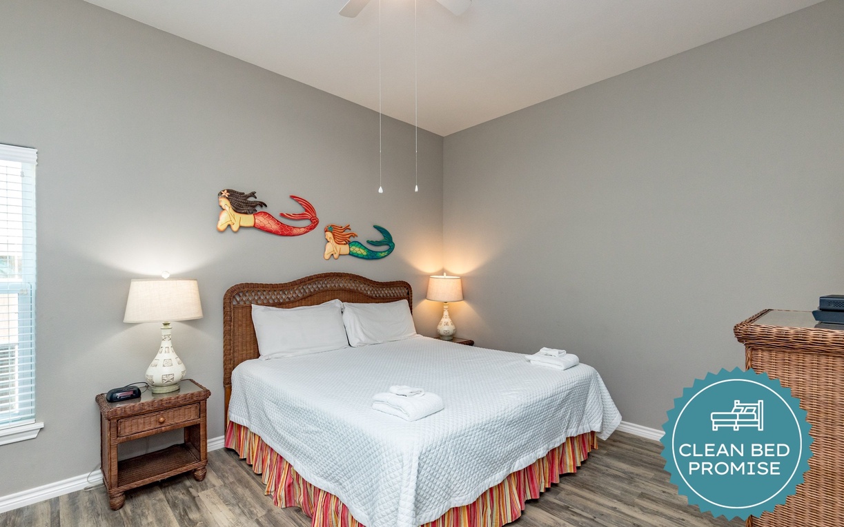 Drift off to sleep in your coastal-themed bedroom, where playful mermaid art and warm lighting create a magical seaside escape.