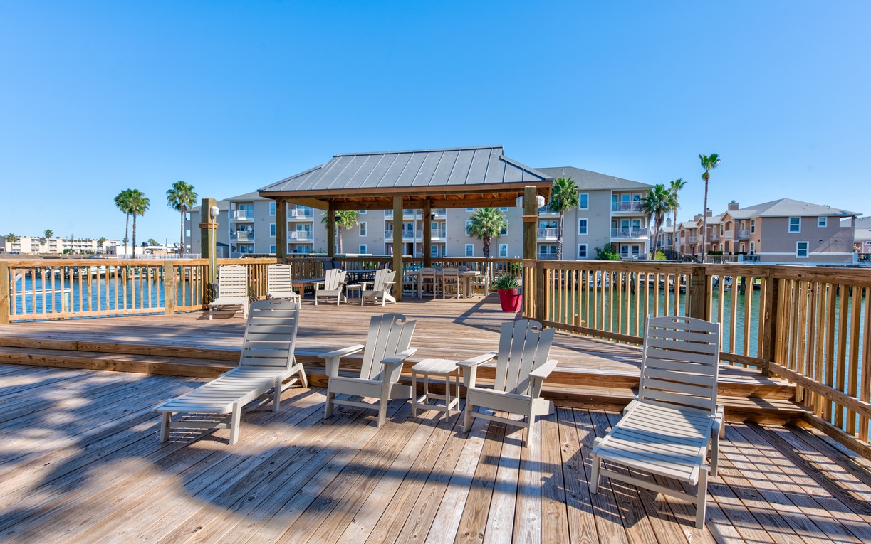 Spacious waterfront deck with comfortable lounge chairs where you can soak up coastal vibes and enjoy stunning water views.