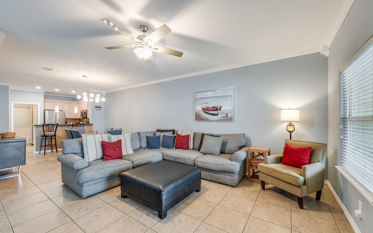 Relax in your spacious living room with plush sectional seating, perfect for gathering with loved ones after beach days.