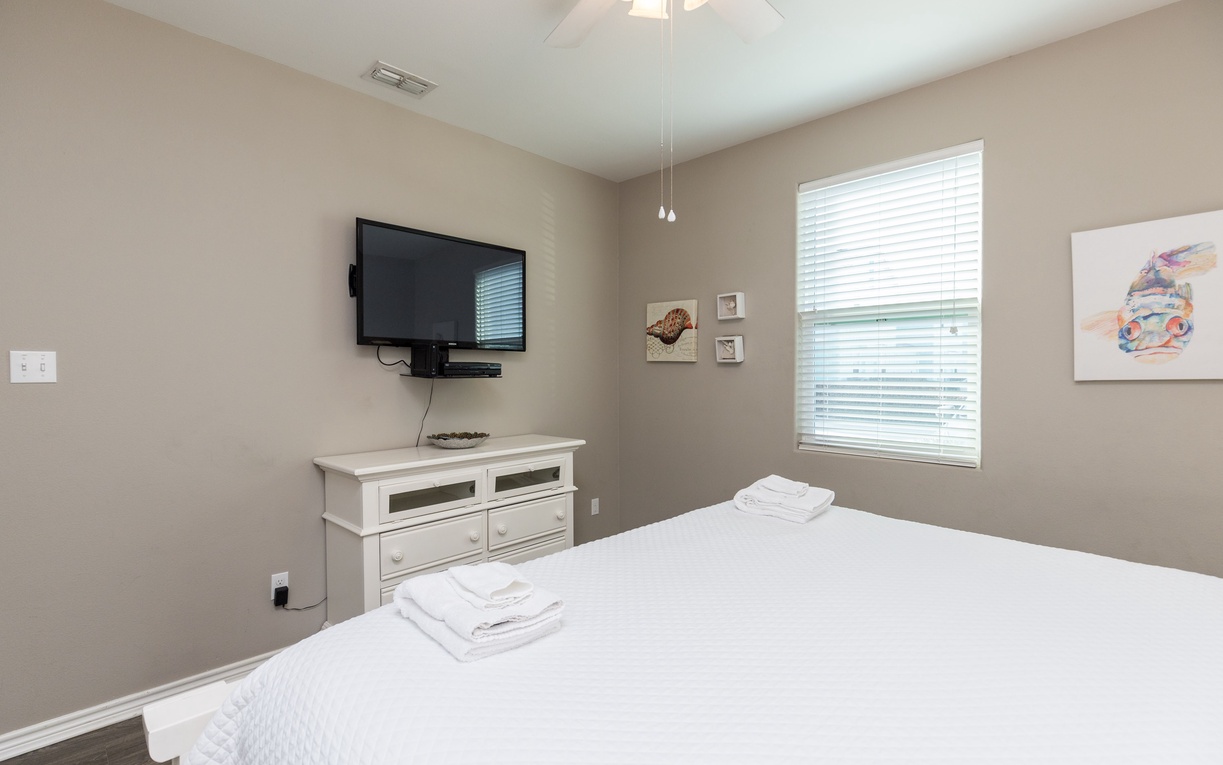 Unwind in your peaceful bedroom with crisp white linens, a flat-screen TV for evening entertainment, and thoughtful touches that make you feel right at home.