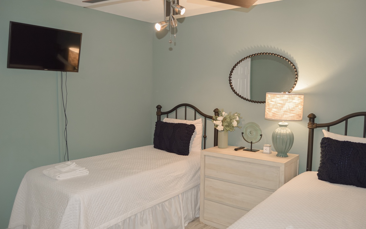 Unwind in your serene cozy twin size beds, and modern amenities like a flat-screen TV and stylish lighting.