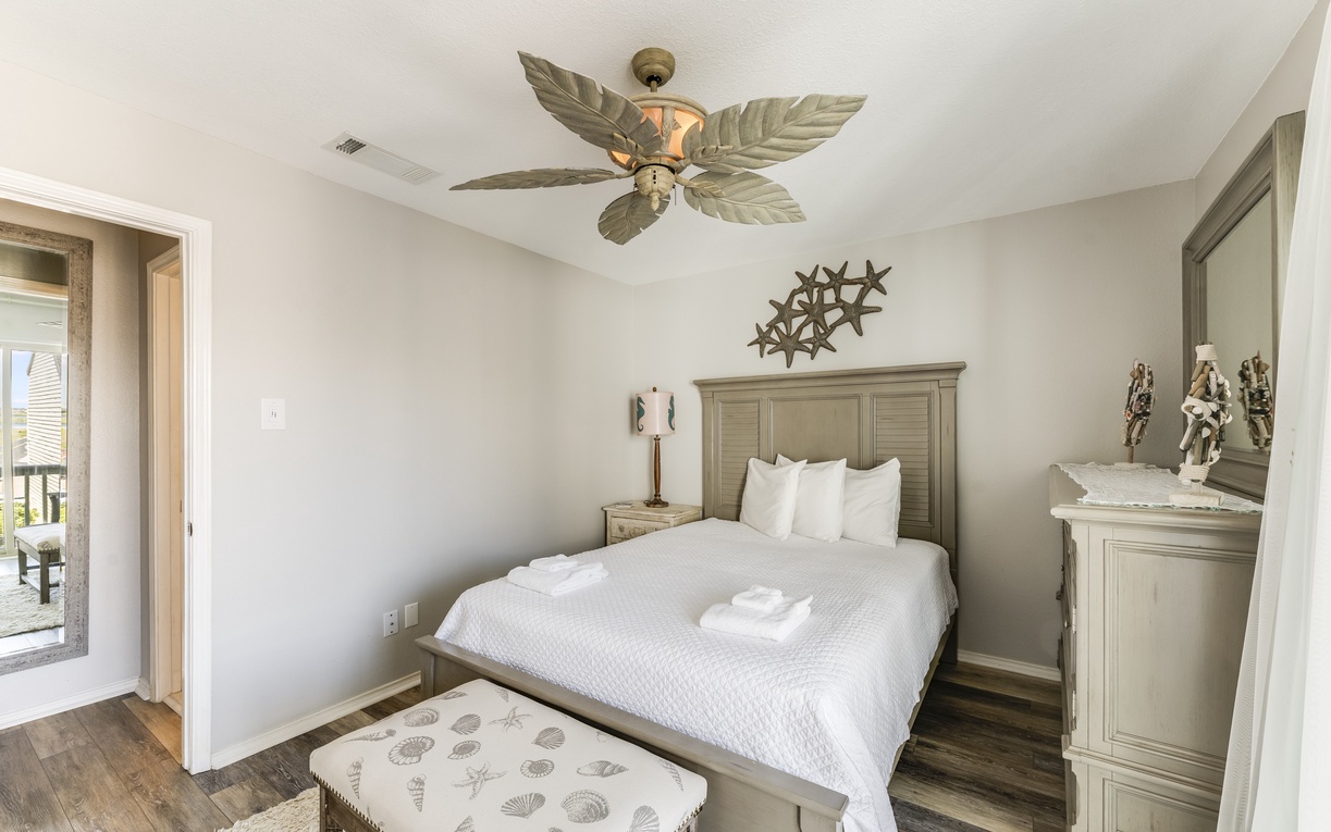 Your peaceful sanctuary features crisp linens, coastal décor, and a tropical ceiling fan to keep you cool and comfortable.