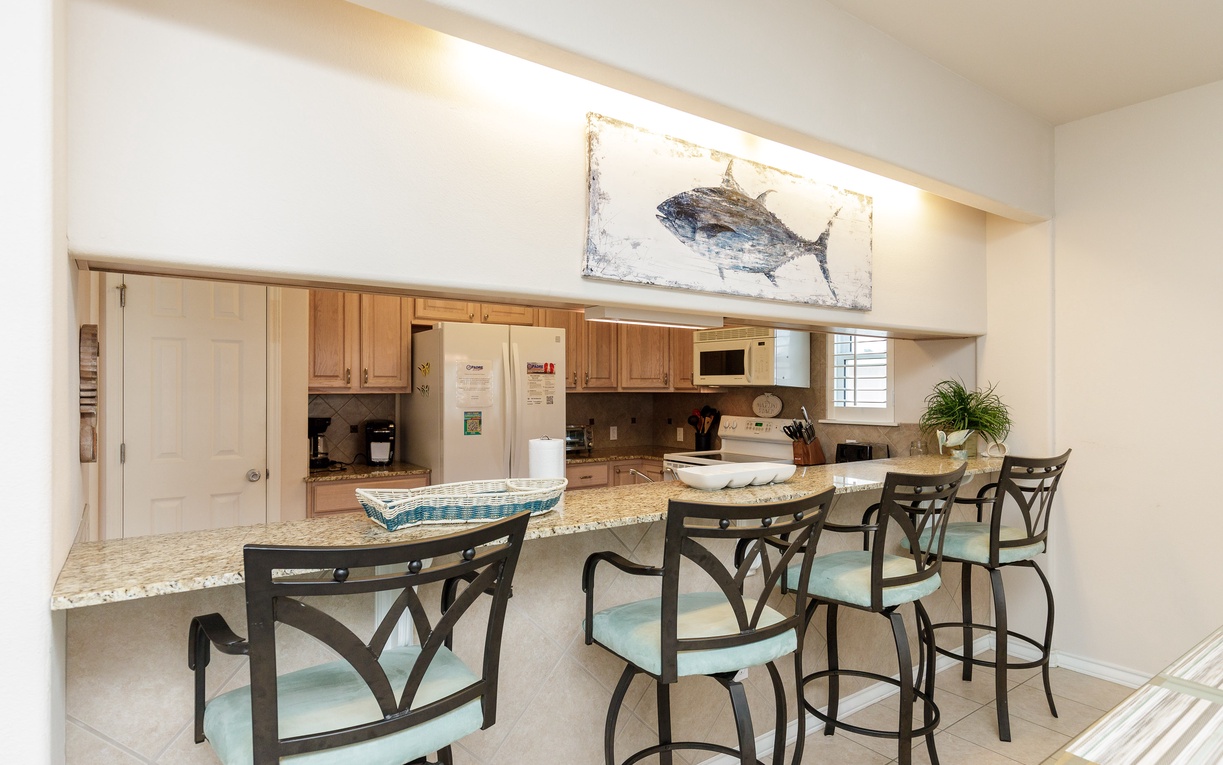 Gather around your spacious kitchen island for morning coffee or casual meals, with granite counters and coastal charm welcoming you home.