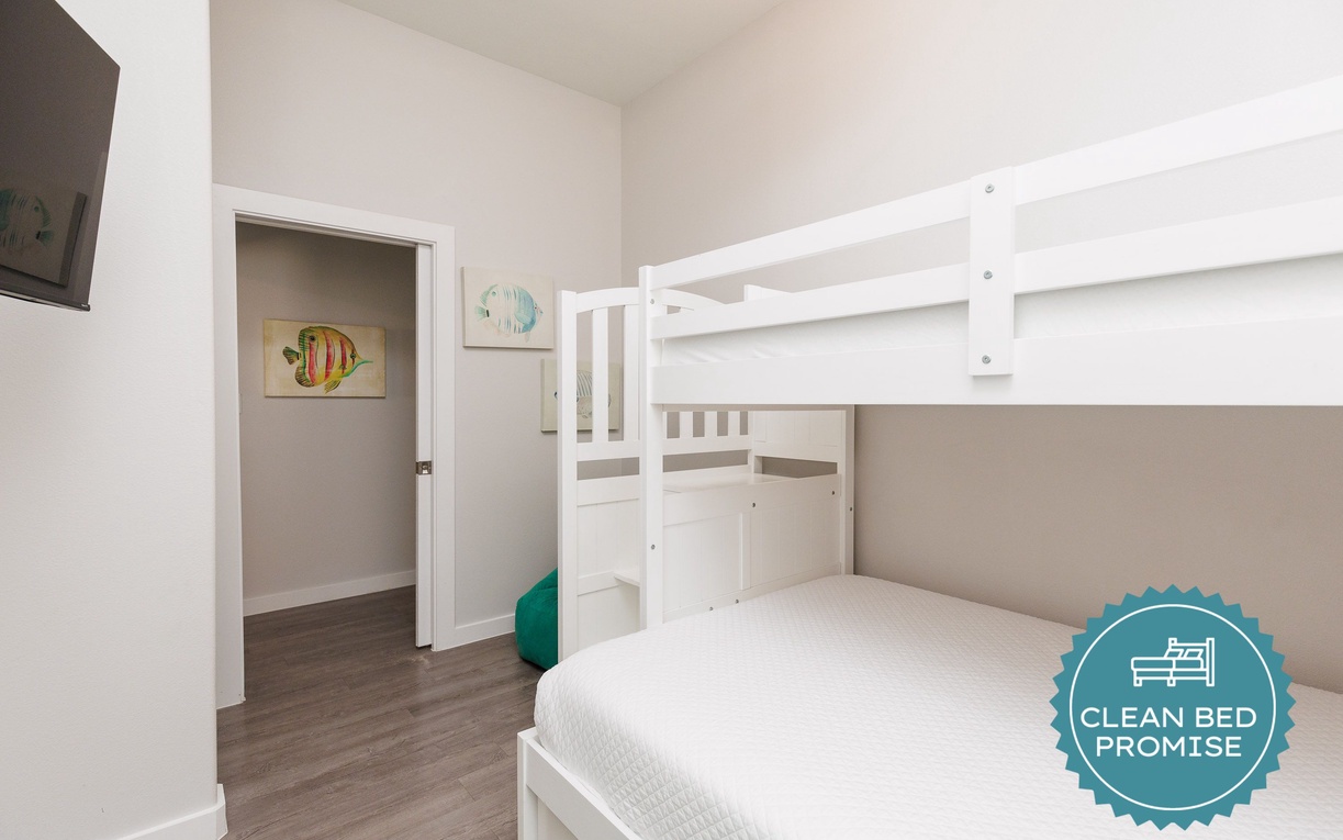 Your kids will love this cheerful bunk bed room with playful fish artwork and cozy white linens for sweet dreams.
