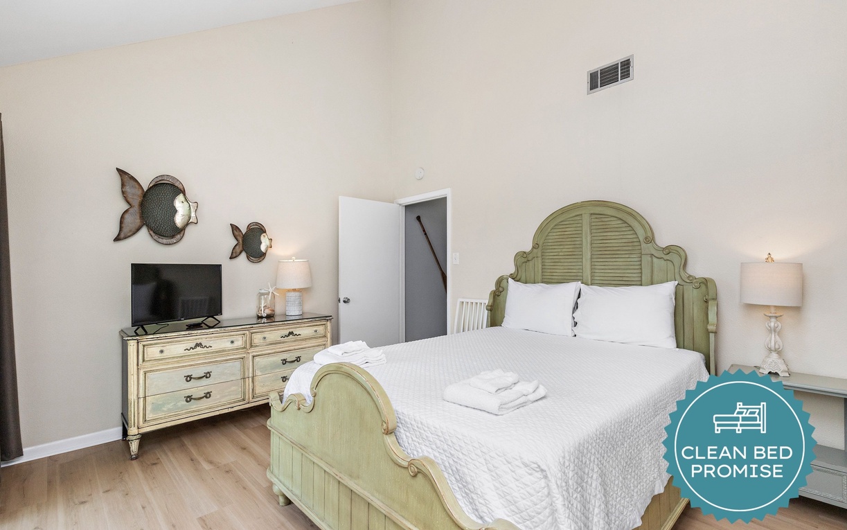 Drift off in your coastal-themed bedroom with whimsical fish artwork and crisp linens inviting peaceful rest.