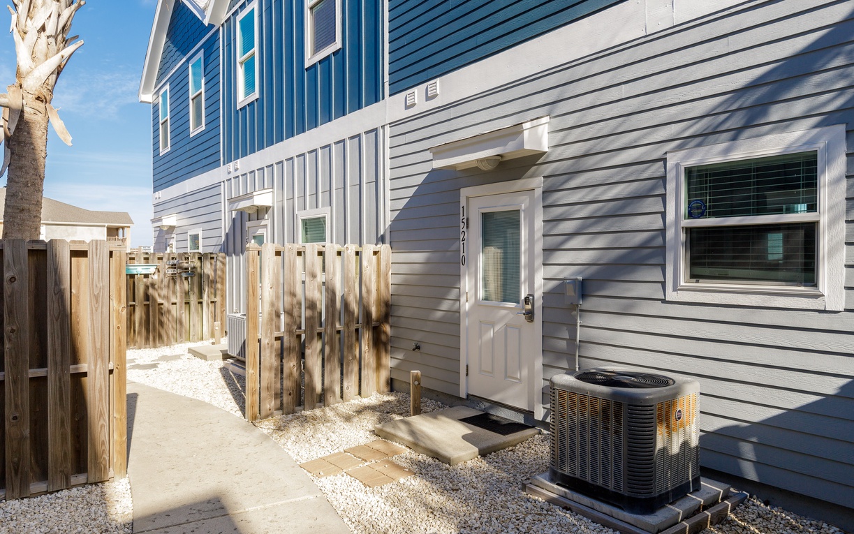 Modern duplex exterior with private entrance and air conditioning for comfortable year-round stays.