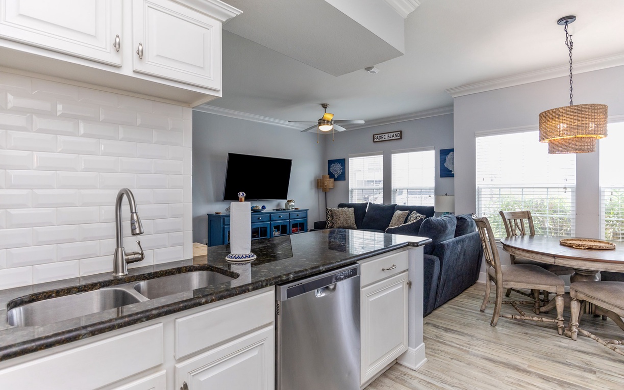 Your open-concept haven seamlessly blends the modern kitchen, cozy living room, and dining space into one inviting area perfect for gathering.