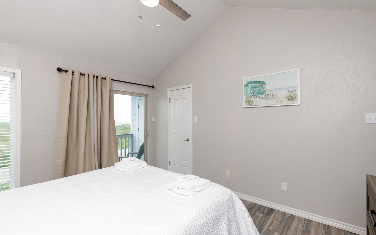 Drift off in your peaceful bedroom with crisp linens, natural light streaming in, and gentle ceiling fan for comfort.