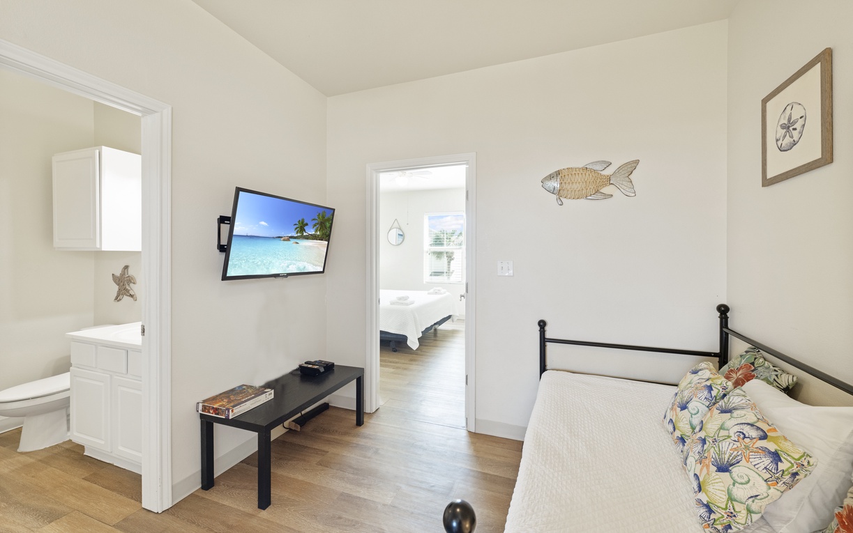 Your coastal-themed bedroom features charming nautical décor and a wall-mounted TV for relaxing evenings after exploring.
