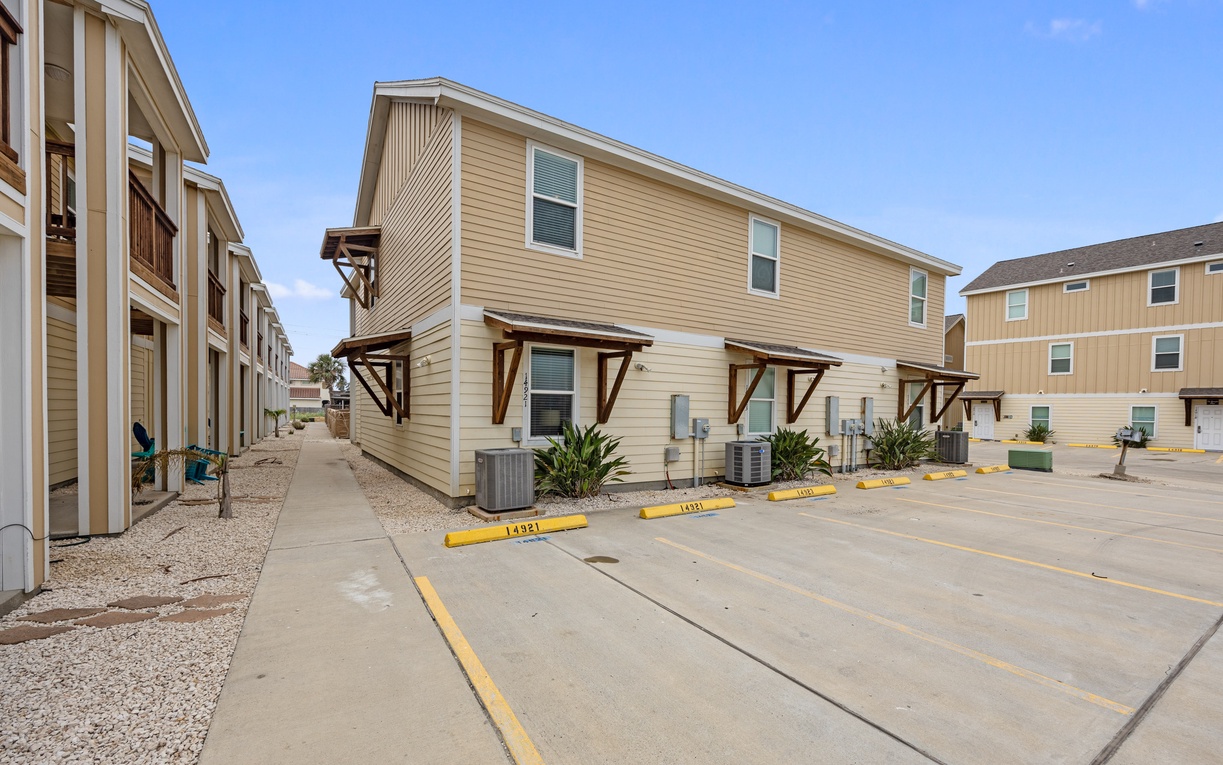 Modern townhomes with convenient parking spaces in a well-maintained community setting.