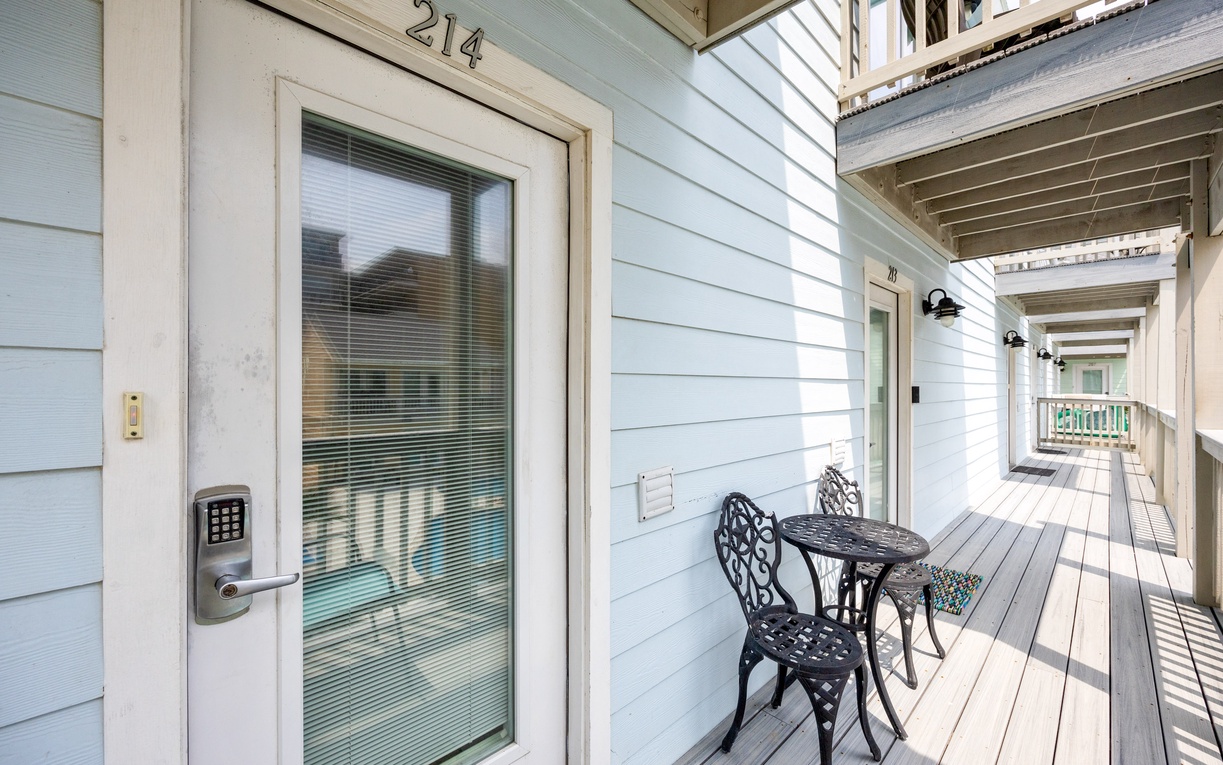 Your private covered deck awaits with comfortable seating for morning coffee or evening conversations in this peaceful coastal setting.