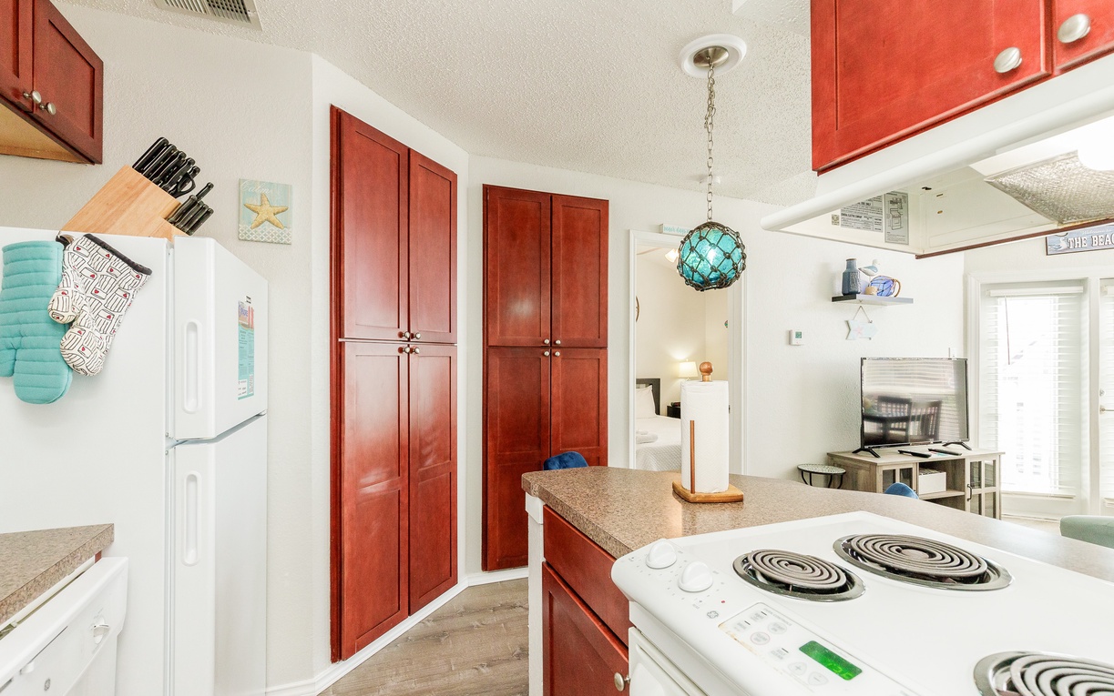 Cook your favorite meals in this fully-equipped kitchen featuring warm cherry cabinets, granite countertops, and modern appliances.