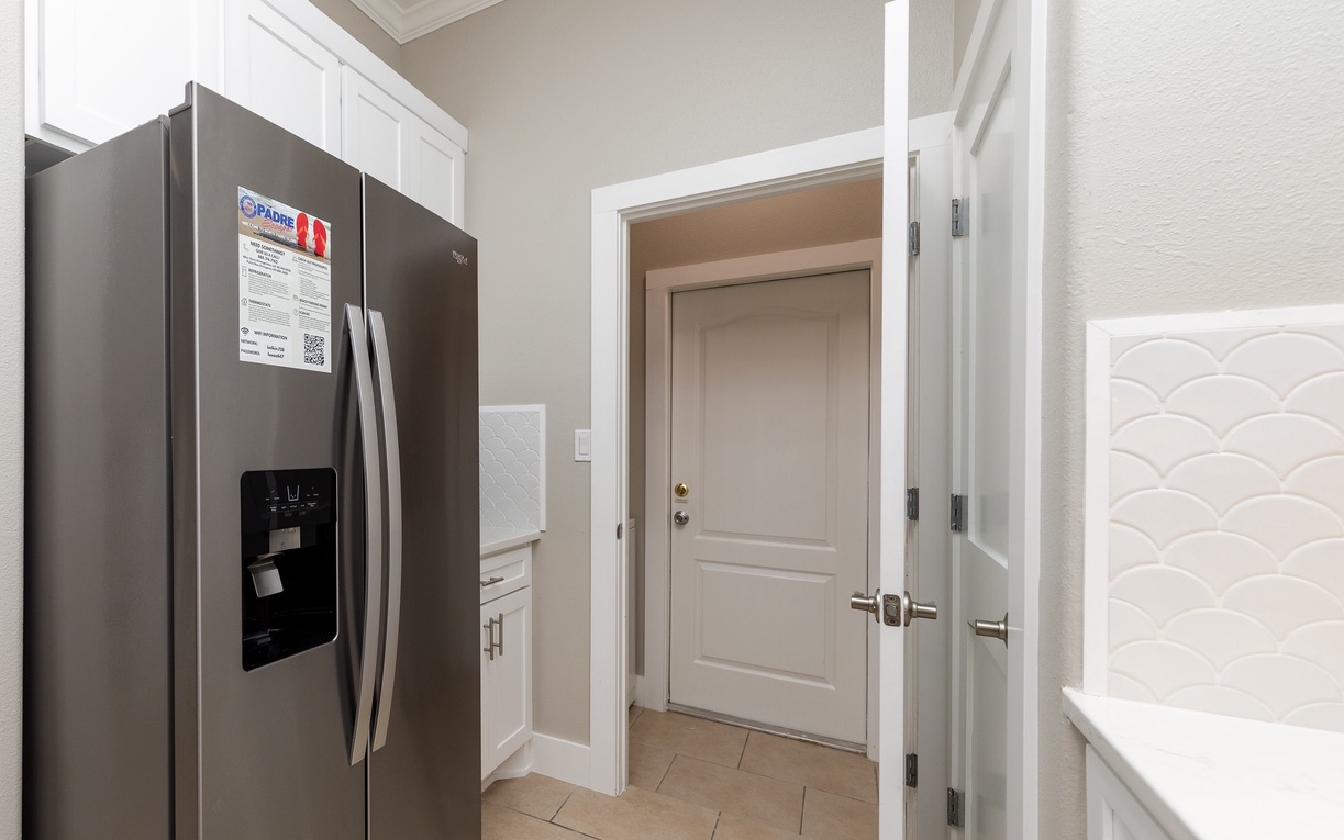 Your spacious kitchen boasts modern stainless steel appliances and elegant white cabinetry, creating the perfect space for preparing memorable meals.